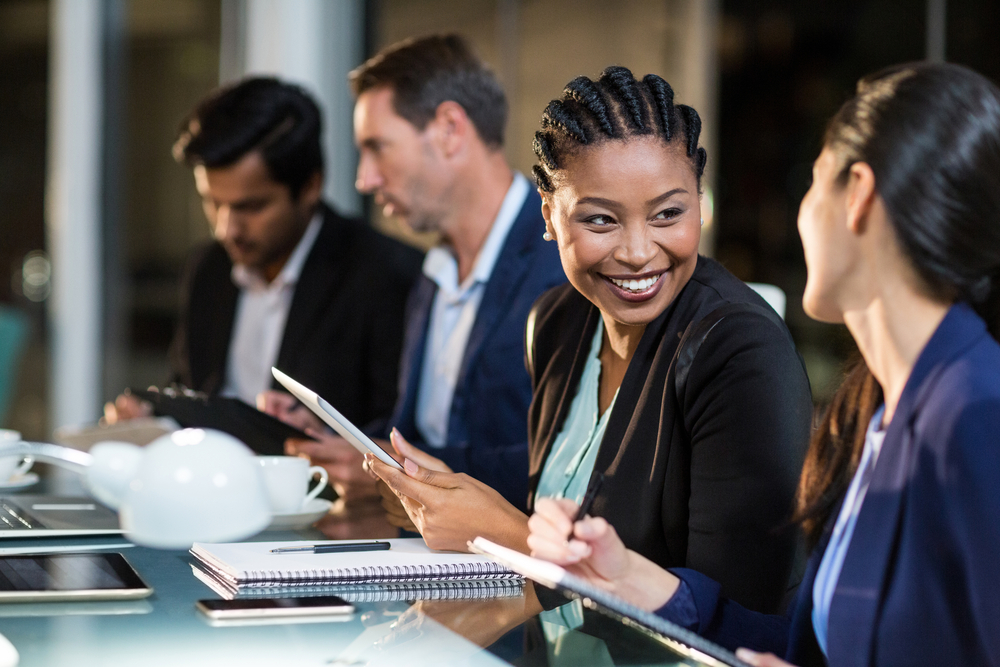colleagues smiling at a client meeting