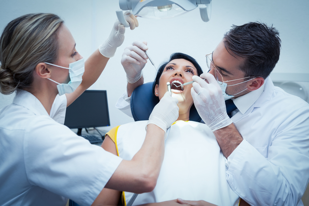 dentist and assistant with a patient