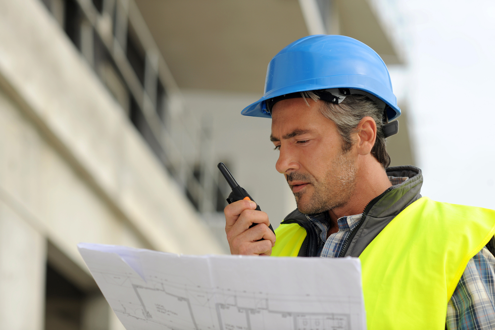 builder checking a design