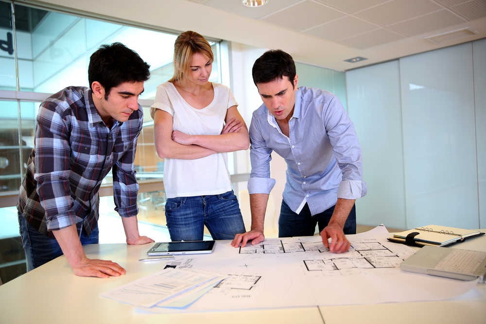 team of architects checking designs