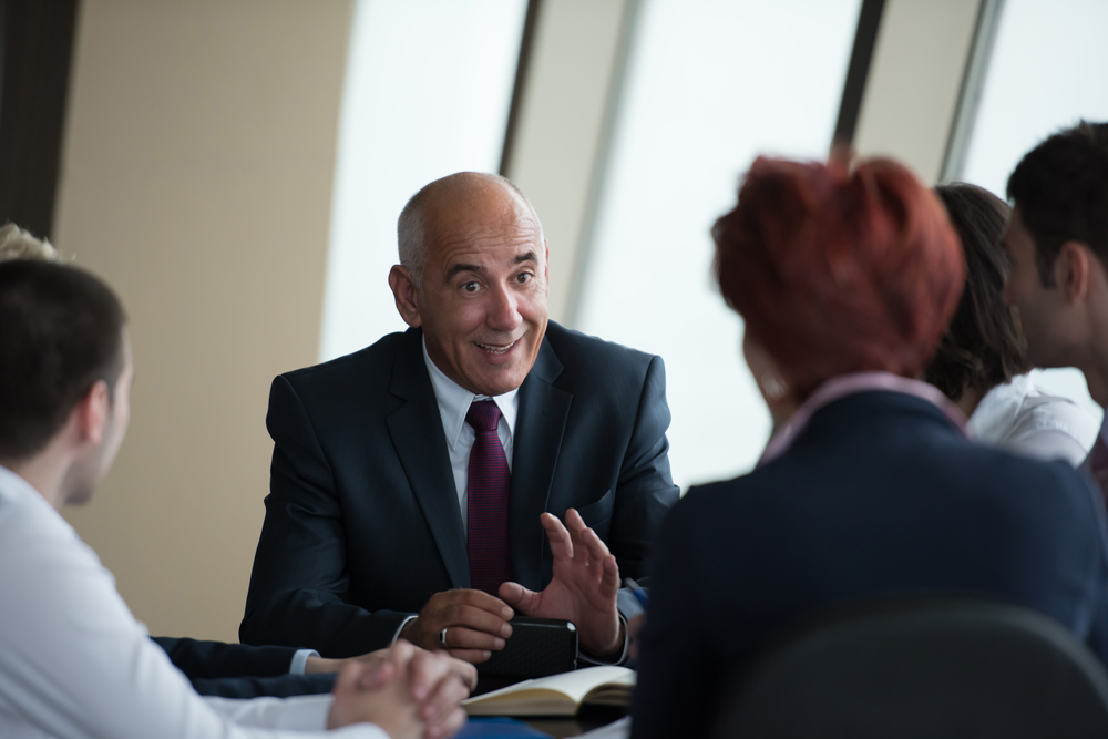 investment bank executive talking with clients